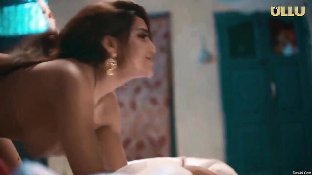 Beautiful Indian babe nude in bed smiling seductively