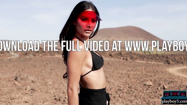 Stunning Hispanic beauty in black bikini posing nude in desert