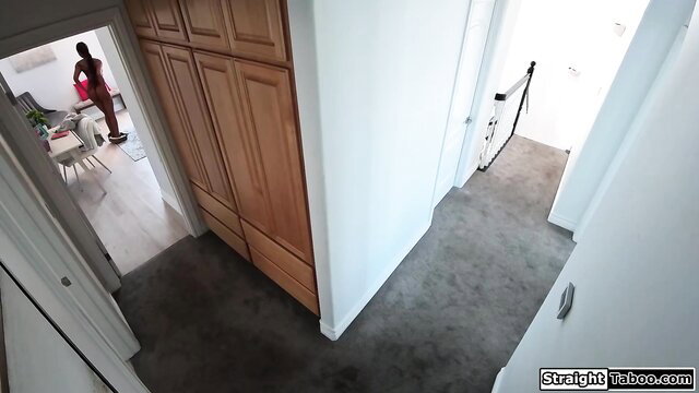 Destiny Mira in red lingerie stands teasingly in hallway