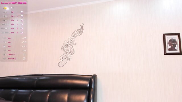 Kade Baby nude full body pose in bedroom with peacock wall art