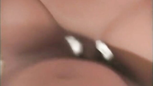 Cute brunette's cleavage with shiny piercings in steamy closeup