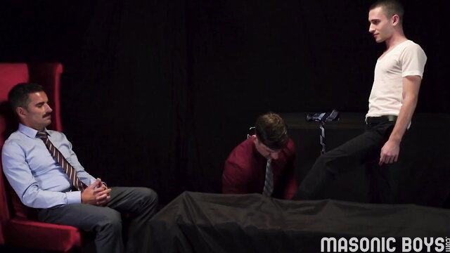 Masonic Boys ritual: suited men with kneeling sub in white shirt tie