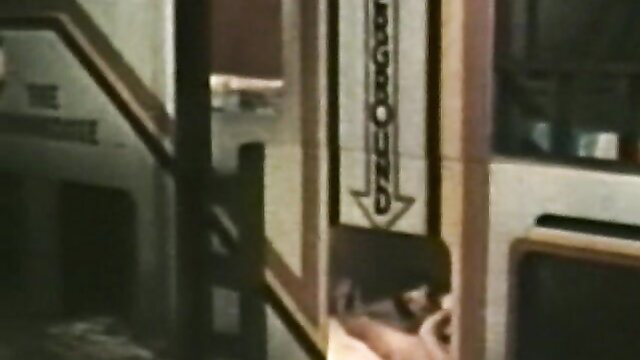 Vintage 70s peepshow loop: brunette peeking at chains on stairs