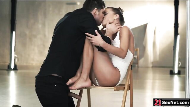 Guy passionately kisses petite girlfriend on chair in hot scene