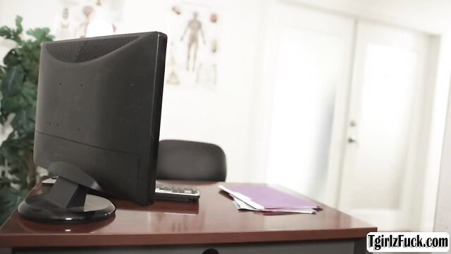 Kasey Kei in clinic office with desk, monitor, doctor skeleton poster