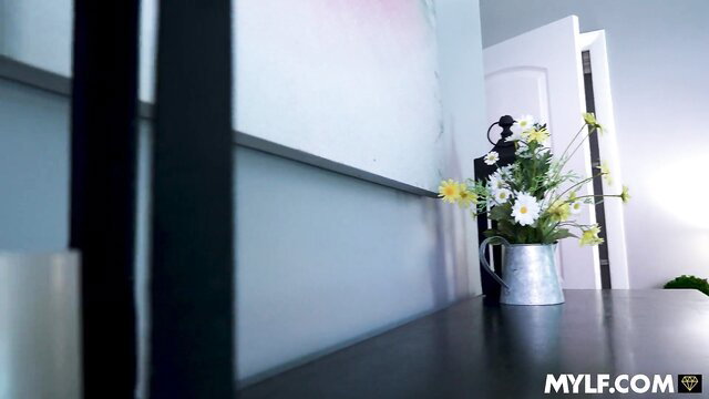 Stepmom’s Blind Spot: Busty MILF by door with flowers in tin can