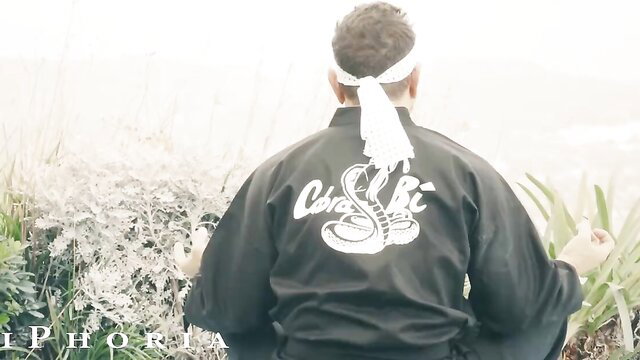 Man in Cobra Kai gi meditating, Isabella Nice lusty BiPhoria video