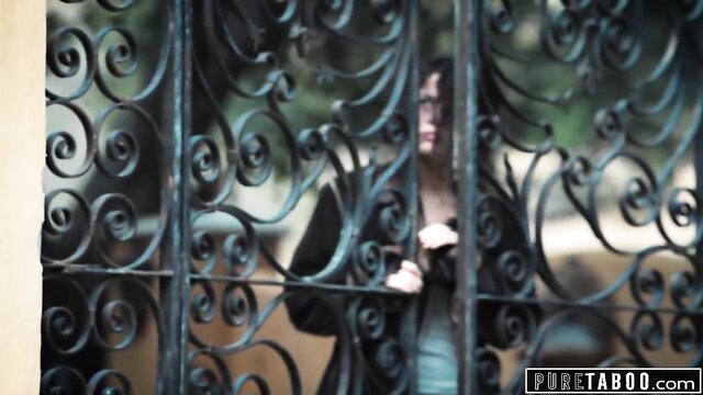 Victoria Voxxx behind wrought iron gate in Pure Taboo trailer