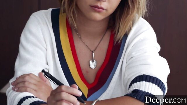 Maitland Ward in colorful sweater necklace holding pen closeup