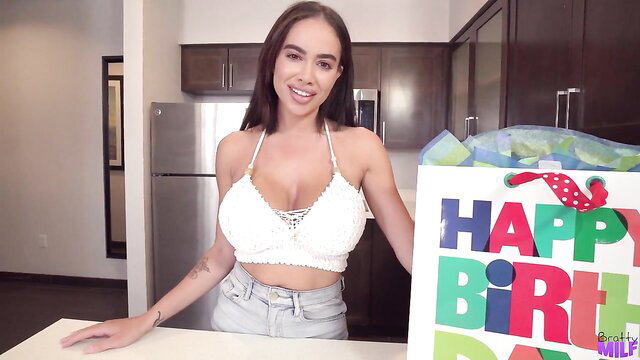 Victoria June busty Latina MILF holds birthday gift smiling