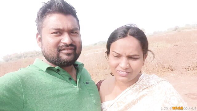 Desi Indian couple selfie: bearded husband hugs smiling saree wife outdoors