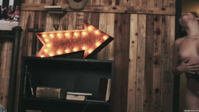 Abella Danger nude in rustic room with neon arrow sign