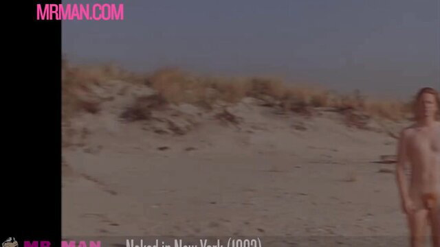 Nude ginger man standing on beach in softcore erotic scene