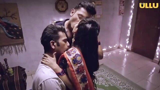 Indian threesome: two men kissing brunette beauty in saree