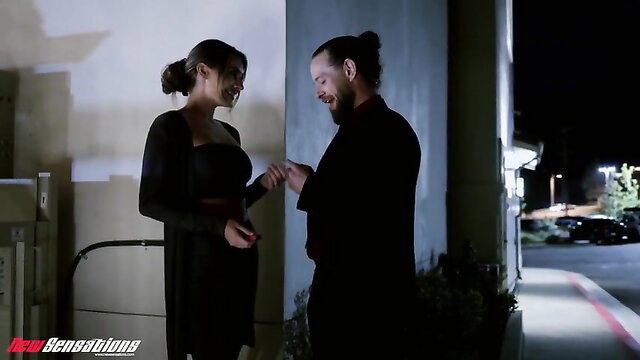 Ella Reese in tight black dress flirts with man outdoors at night