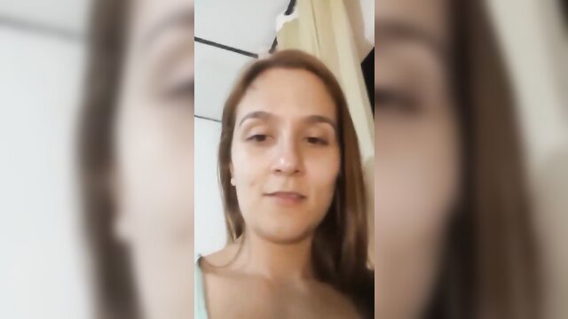 Closeup of young Latina amateur girl's smiling face in selfie video