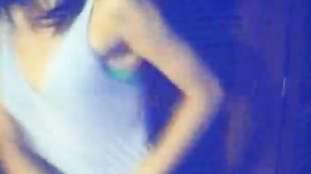 Blurry closeup of busty Latina in white tank top exposing underboob