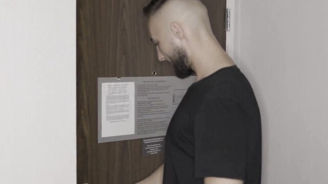 Bald Milan Ponjevic reads notice by door in steamy Armani Black scene