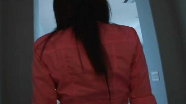 Lexi Stone in red blouse, long black hair from behind