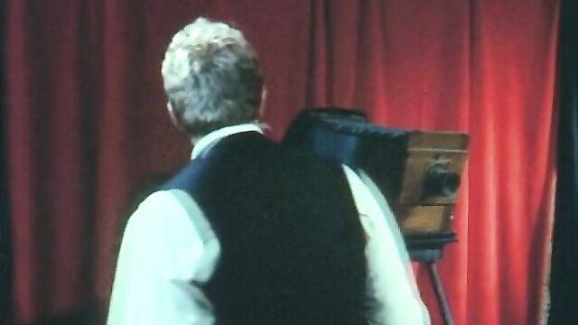 Man standing in front of a vintage camera