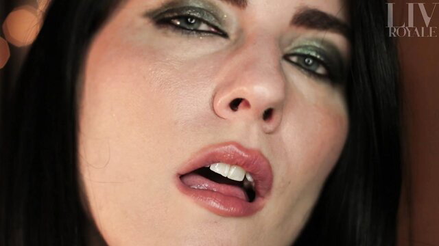 Liv Royale's seductive closeup with glossy lips and smoky green eyes