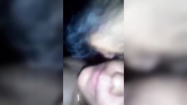 Blurry closeup of Desi girl with blue smoke kissing lover on wedding night