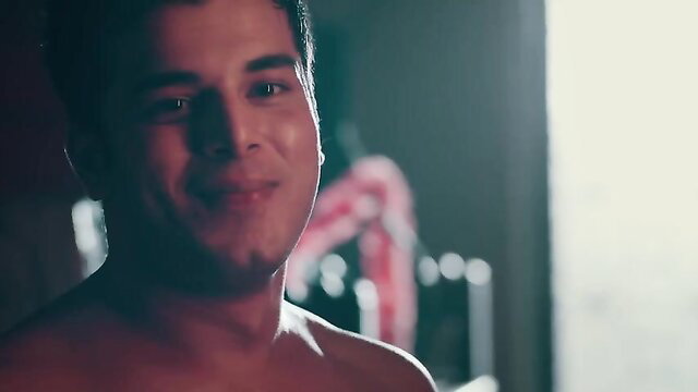 Shirtless handsome Indian man smiling seductively in hot scene