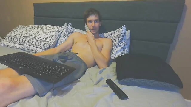 Shirtless hunky guy lounging nude torso on bed in Chaturbate teaser