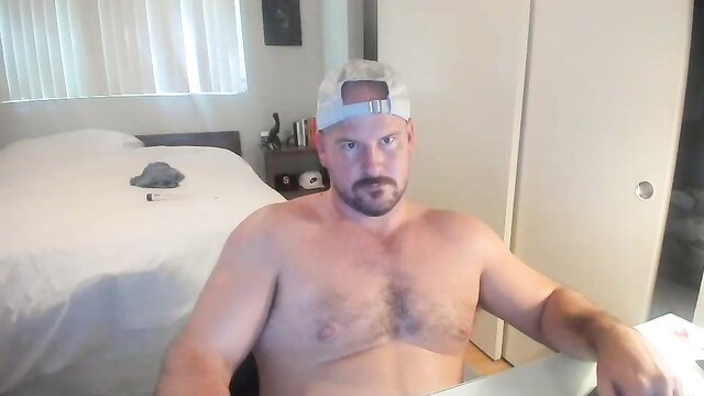 Bald muscular white guy shirtless in Chaturbate live stream