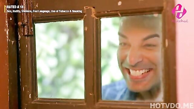 Smiling Indian man peeking through window in Hulchul hot web series thumbnail