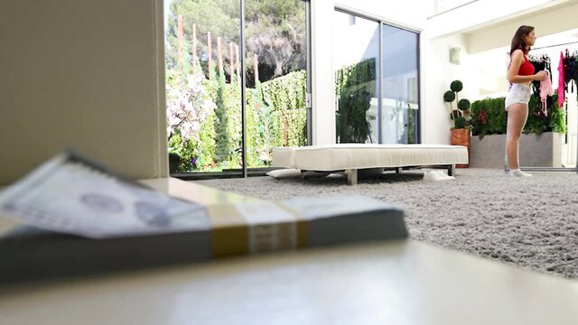 Hotwife Latina MILF in thong browsing clothes by cash stack in sunny room