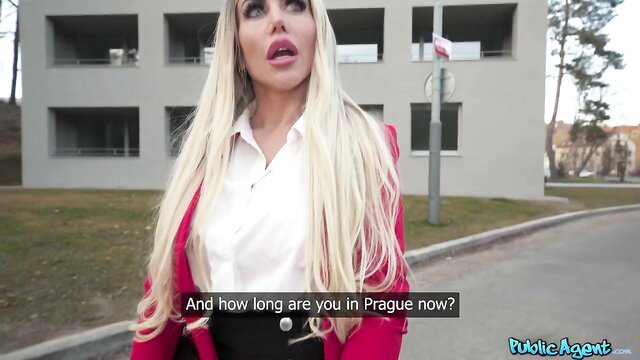 Blonde bombshell Carla Boom in red coat, white shirt in public Prague