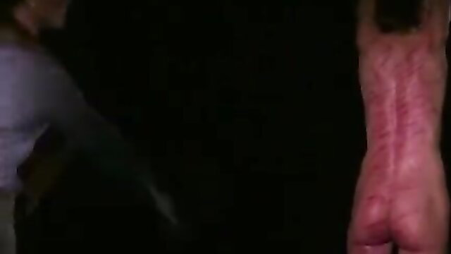 Cute MILF's raw red back from painful lezdom whipping punishment