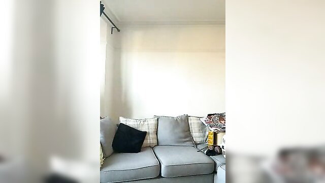 Curvy babe lounges on couch with pillows in teasing pose