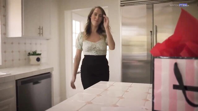 Anya Olsen in sexy lace top and skirt holding pink gift bag