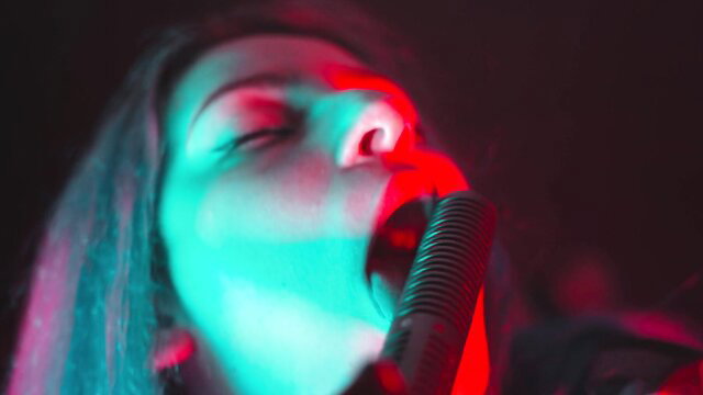 Closeup of woman sensually licking microphone with open mouth ASMR tease