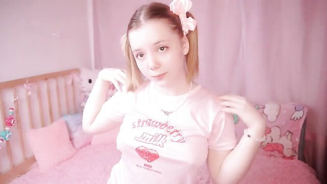 TinyKiki in strawberry shirt pigtails poses cutely in pink bedroom