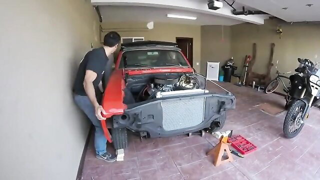 Muscular middle-aged guy with big uncircumcised cock in garage car repair