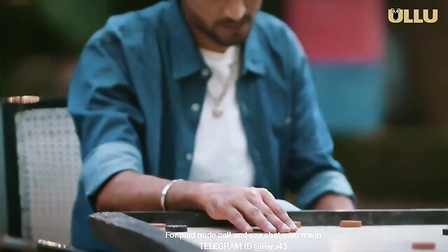 Handsome Indian man in blue shirt playing carrom game