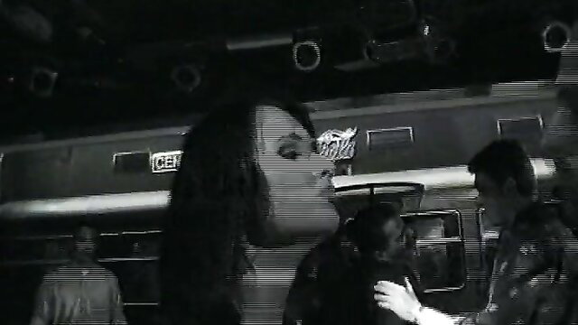 Vintage black & white Italian threesome with giant mask woman and two men by train