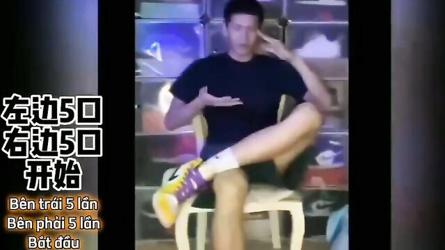 Asian trainer in Nike sneakers sits legs spread, popper handle tease