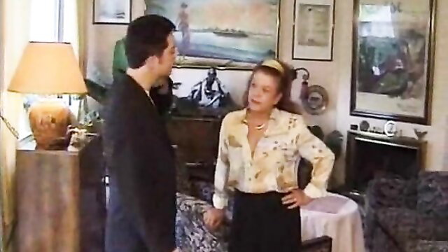 French mature blonde in silk blouse confronts suited man in tense family scene