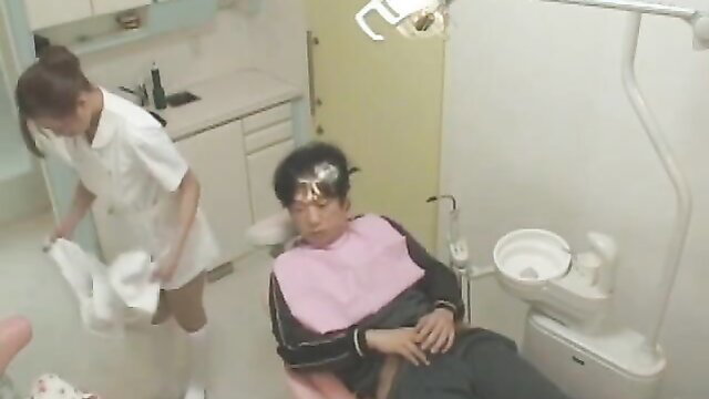 Japanese dentist in short nurse uniform preps sleeping male patient