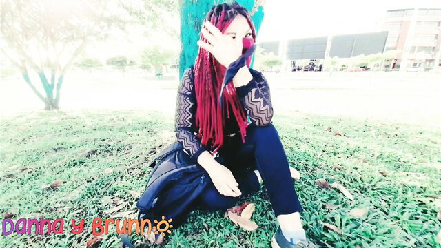 Redhead Latina with dreads in lace top poses sexy outdoors park amateur