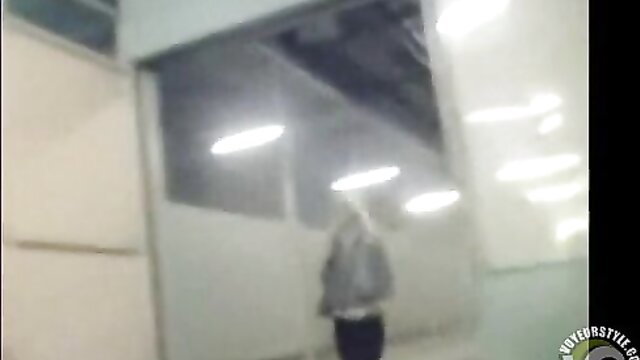 Blurry voyeur cam of clothed guy in public bathroom spy video