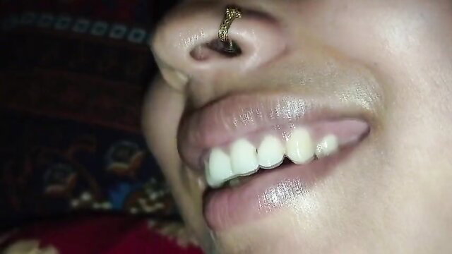 Closeup of smiling Desi Bhabhi's lips and gold nose ring, village tease