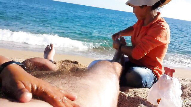 Older Asian babe massages hairy legs on beach, wet pussy play