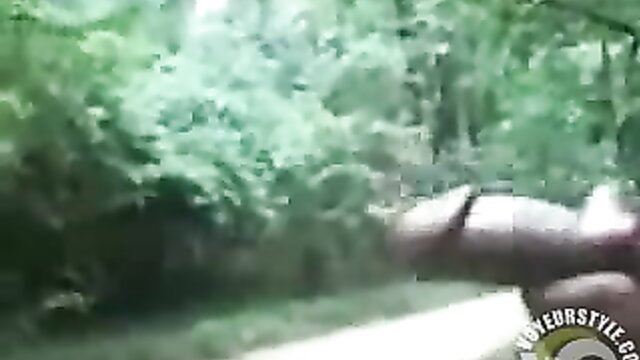Man jerks huge cock in public woods, blurry curvy voyeur watches cumshot