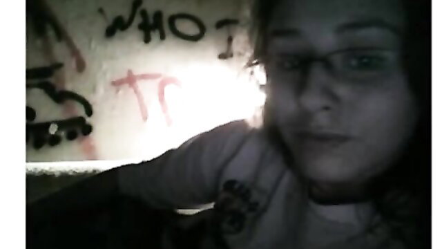 Amateur teen cam girl with glasses smirks naughtily on webcam