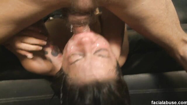 Woman upside down deepthroating man, face soaked in tears and saliva
